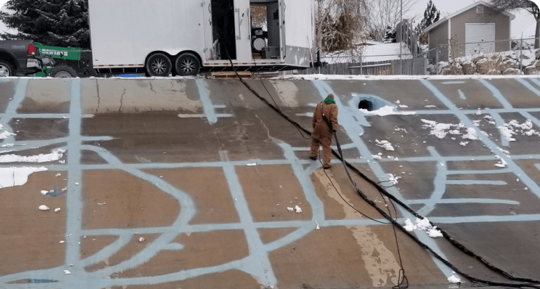 workers repairing concrete canal with polyurea coating